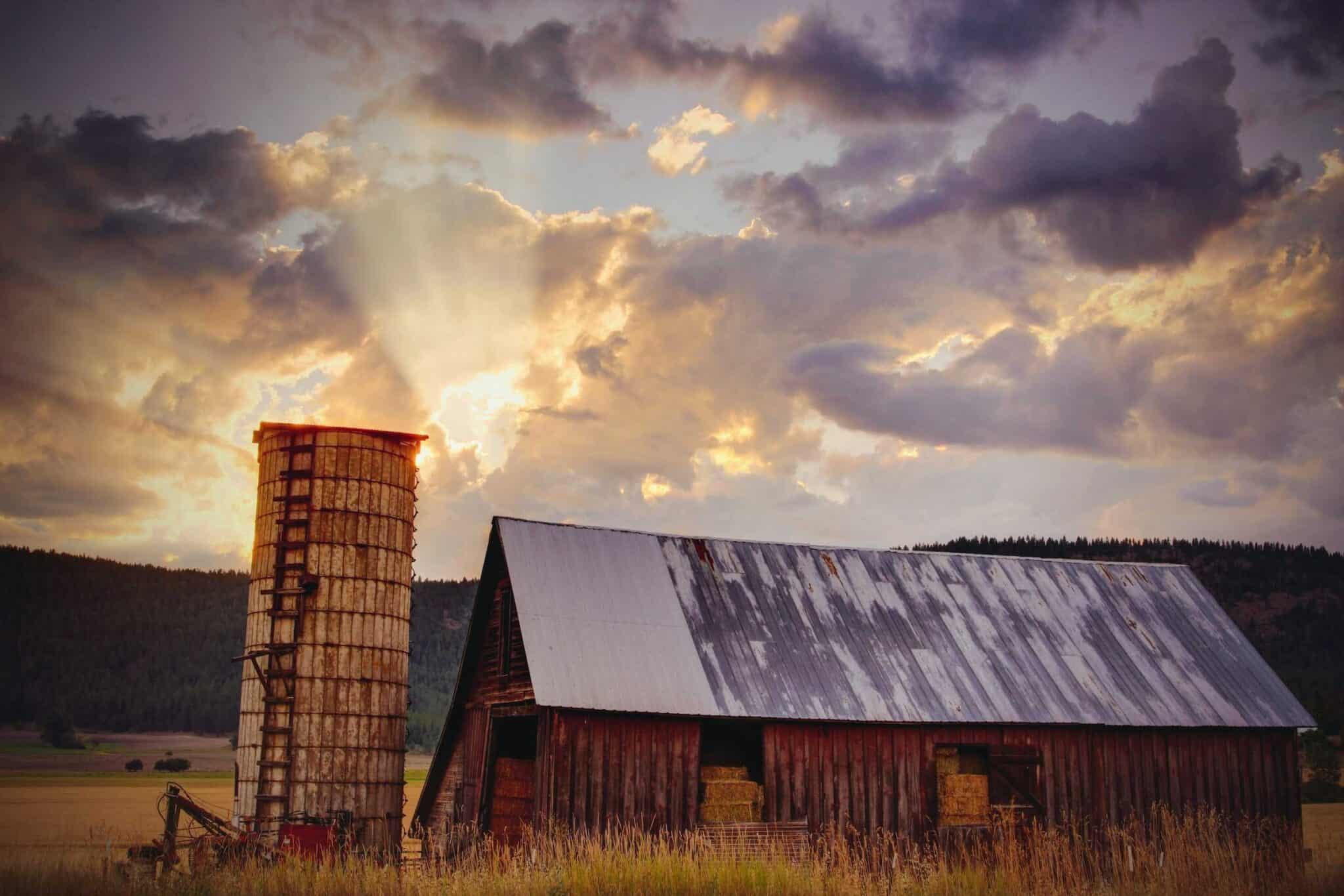 An old worn down barn with weathered roof and paint