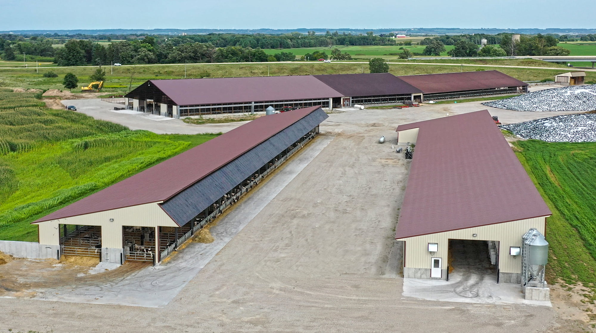 Drone view of Plum Creek Dairy and three large free-stall cattle barns