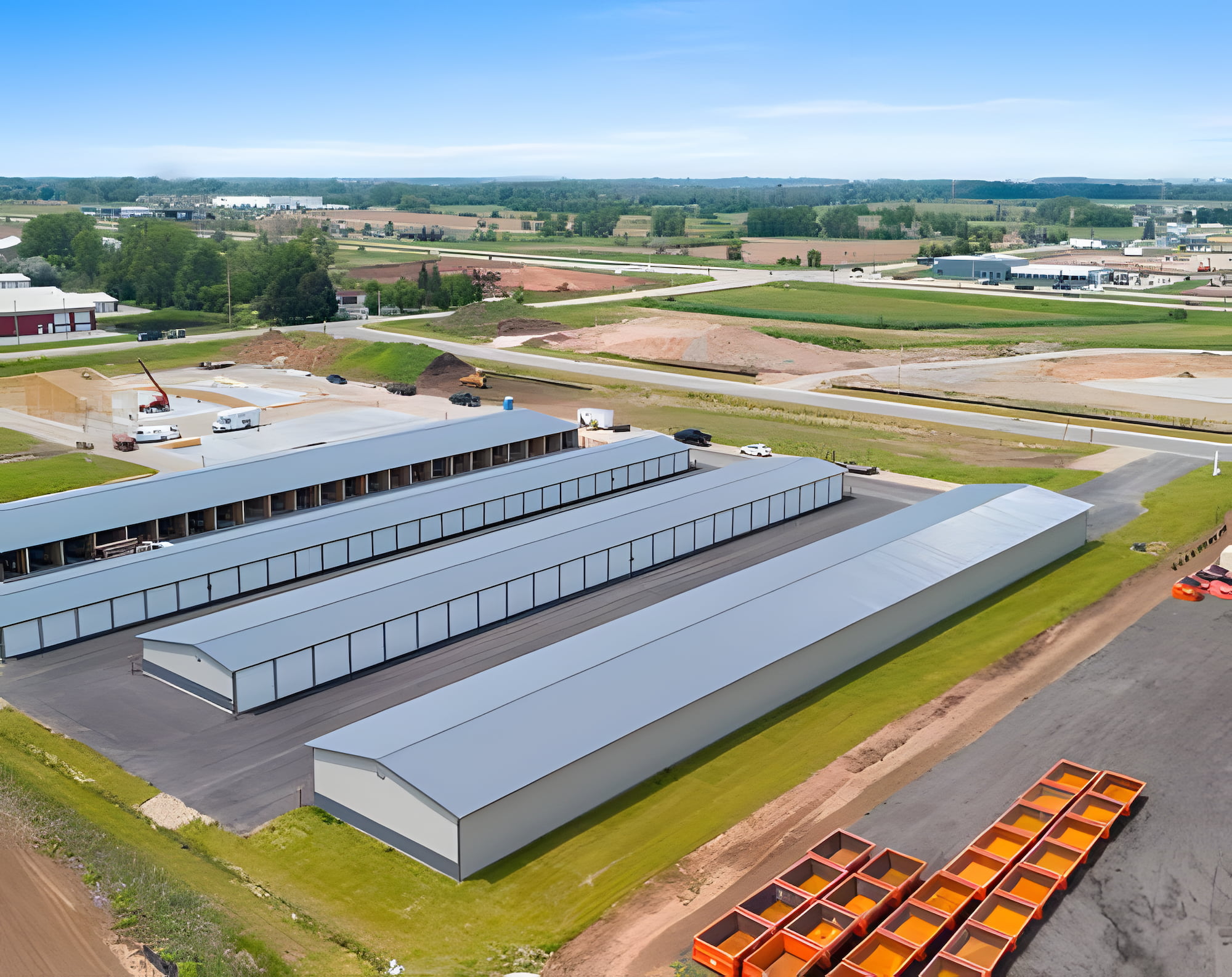 Aerial view of a large storage facility featuring a spacious warehouse and surrounding outdoor storage areas.