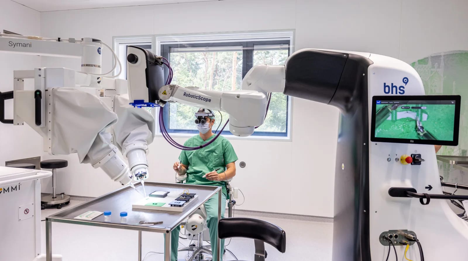 Humanoid robot arm performing precise surgery on a pig model with human assistance.