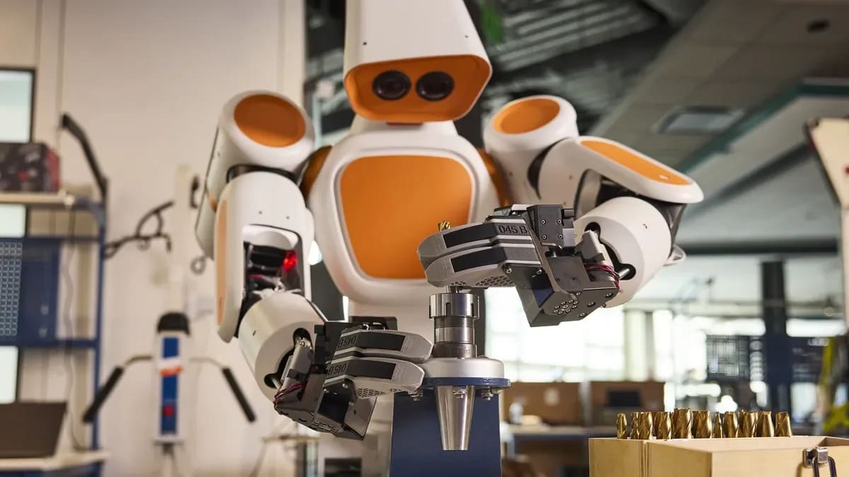 Walden Robotics humanoid robot working alongside a human worker on a Toyota assembly line