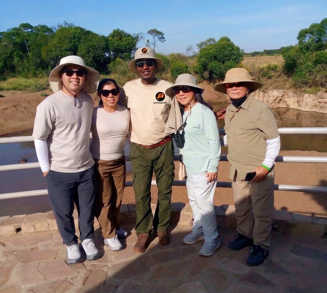An Out2safari lead guide with guests in the field