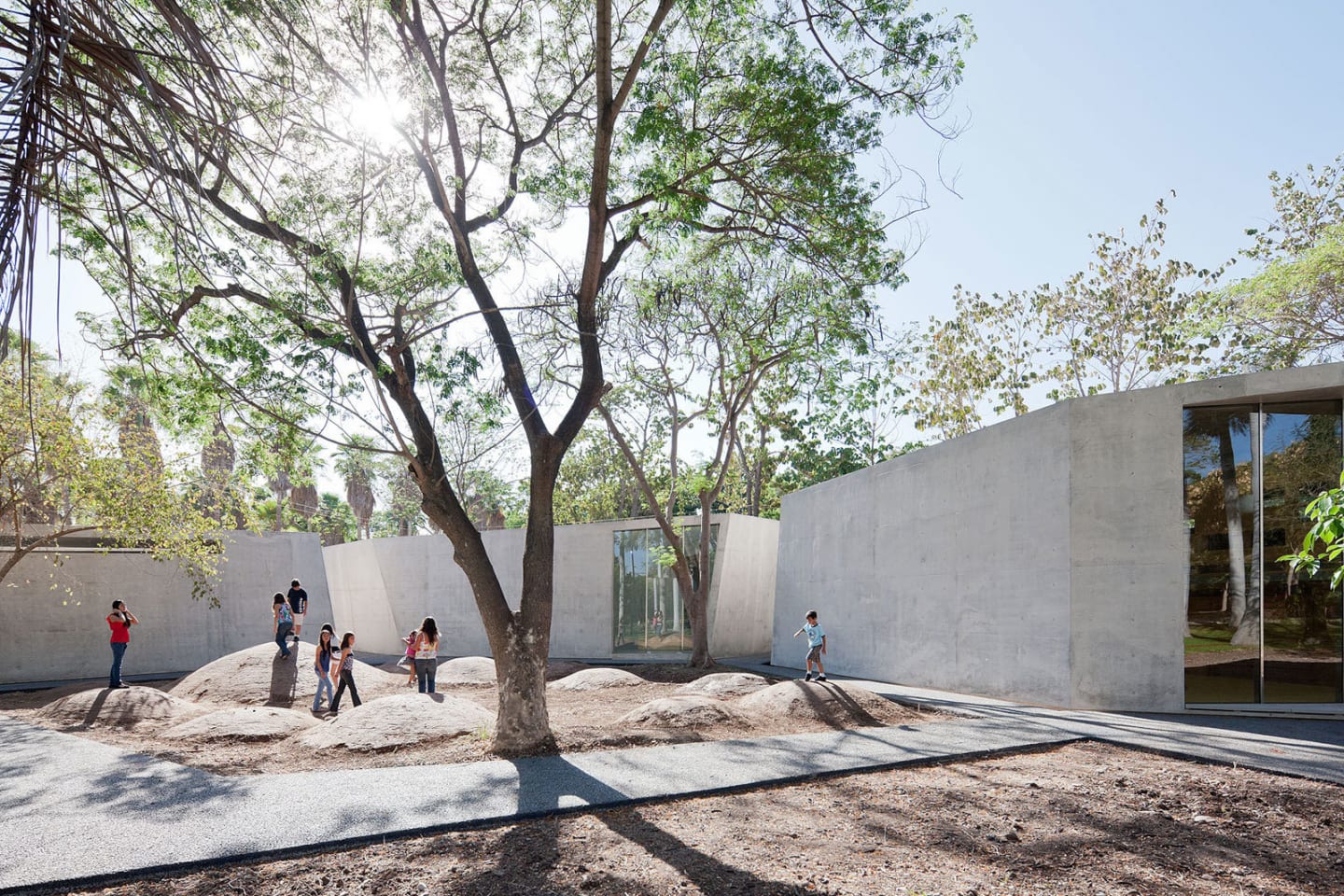 Children playing in the courtyard of the Culiacán Botanical Garden, surrounded by minimalist concrete pavilions designed by Tatiana Bilbao. Photo by Iwan Baan.