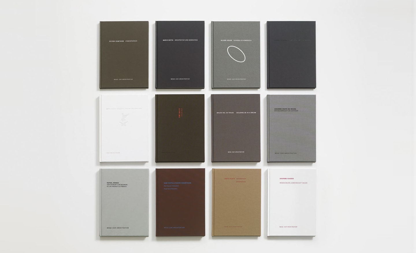 Twelve FSB books from the series “Wege zur Architektur” are arranged in three rows and four columns, their covers in shades of white, gray, and earth tones.