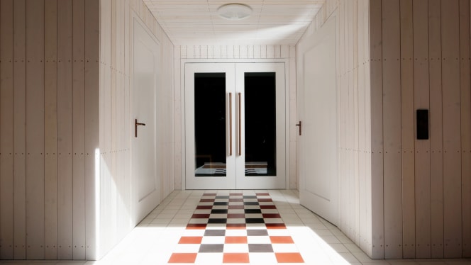 Interior view of the Christuskirche, renovated by Bayer Uhrig, featuring checkerboard tiles and door hardware by FSB.