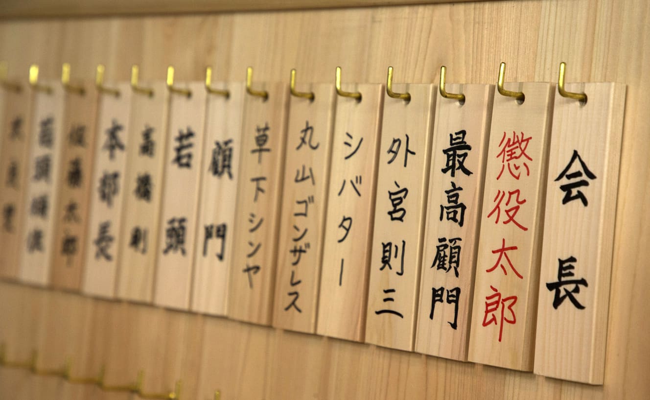 「更生会本部」の壁に設置された木札。懲役太郎氏は「会長」だが、懲役に行っているという設定のため、赤字になっている