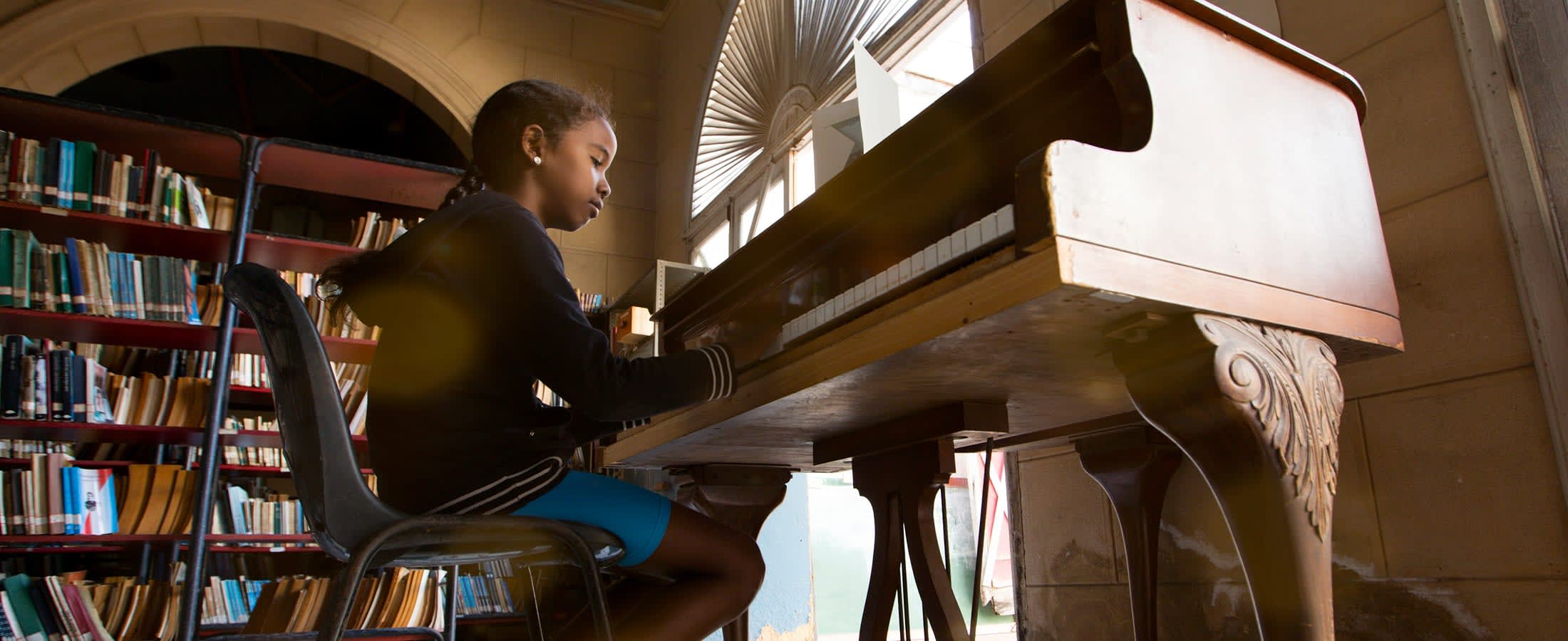 Young girl practicing piano, Havana