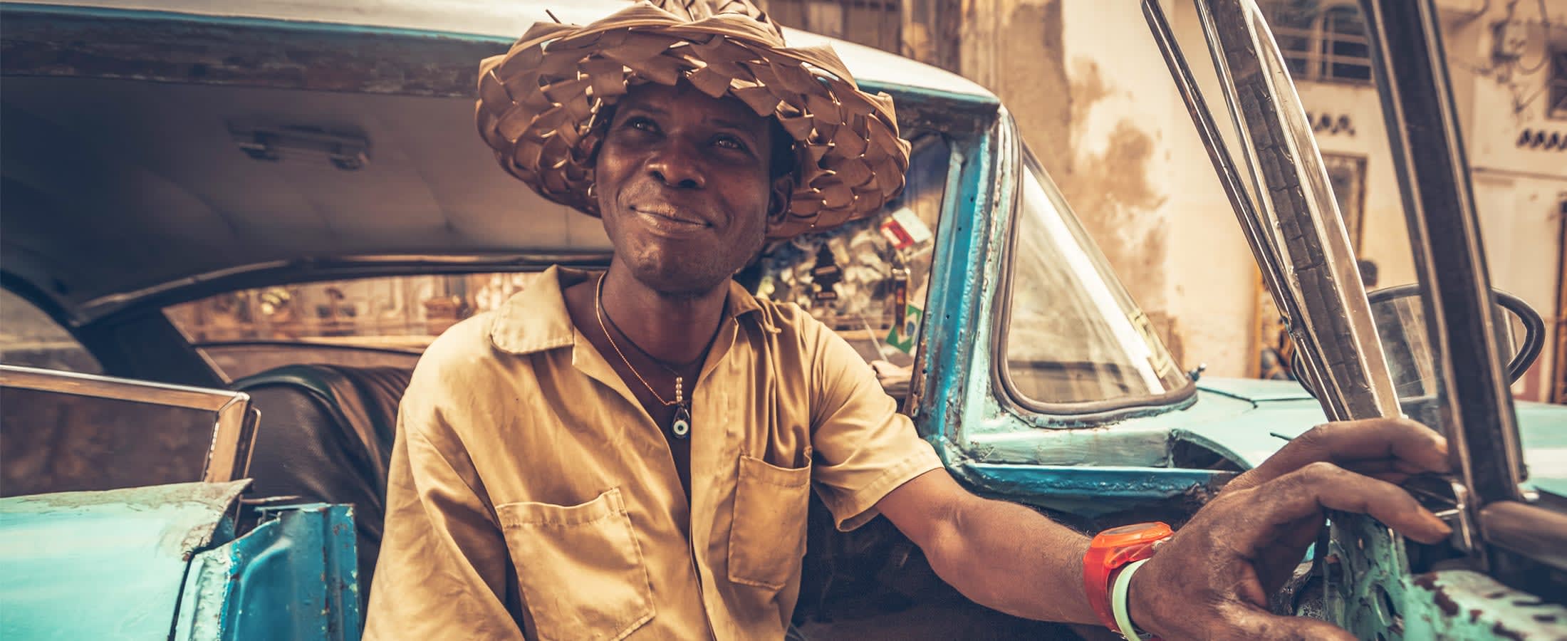 Portrait of a Cuban man in his vintage car, Havana