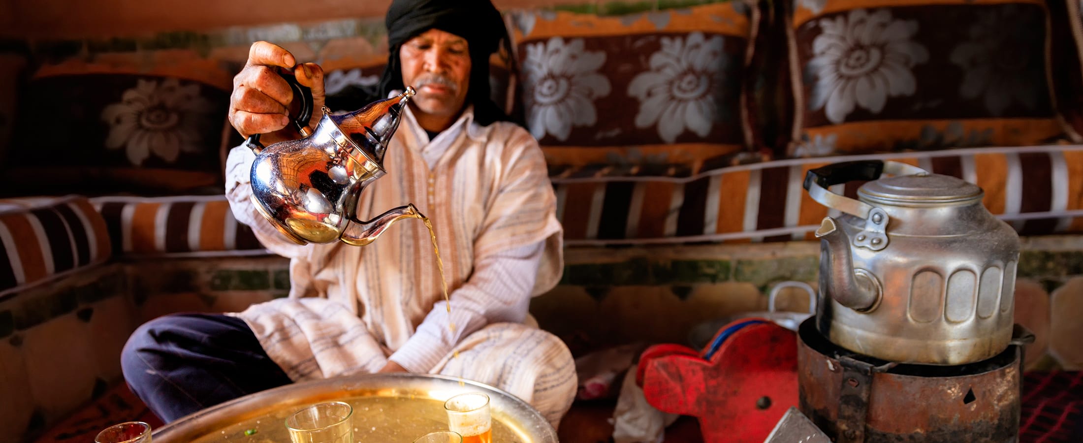 Moroccan man preparing Maghrebi mint tea