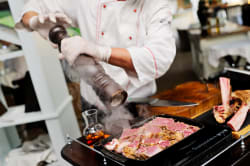 Preparing a meal, Carnivore Restaurant