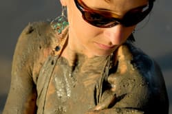 Woman applying mud to her skin, Dead Sea 