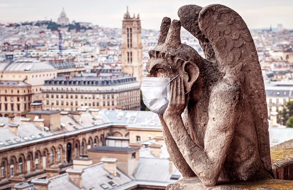 gargoyle wearing mask in Paris, France