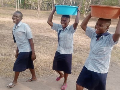 Students carrying water