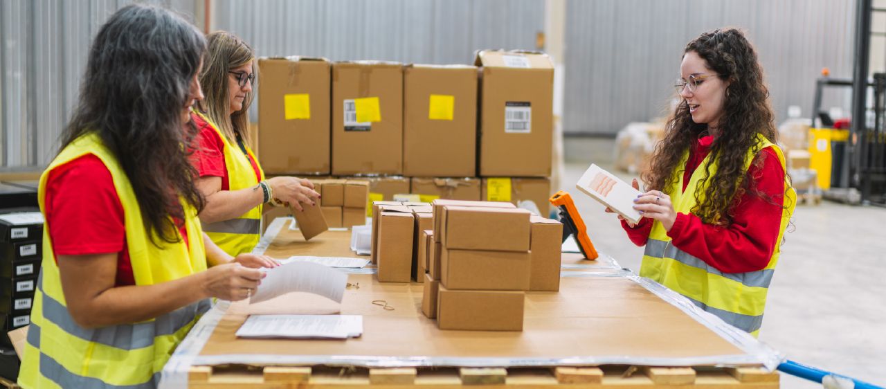 Warehouse team preparing packing slips and boxes for 3PL order fulfillment