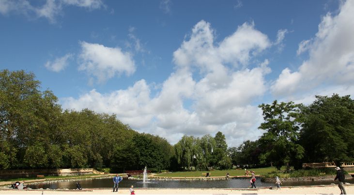 people walking around the lake in bishops park