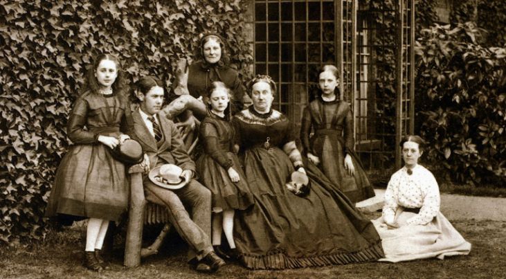 black and white photograph of bishop taits wife and four children outside of the palace