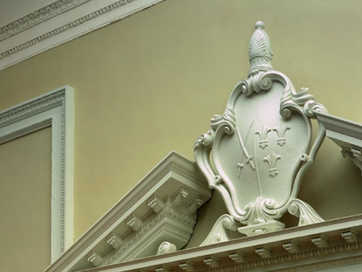 bishop sherlocks coat of arms above doorway in restored dining room