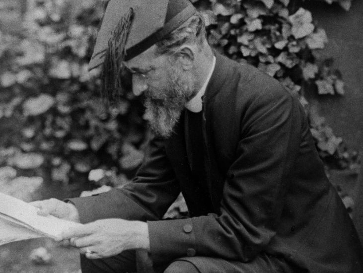 photography of bishop mandell creighton siting and reading