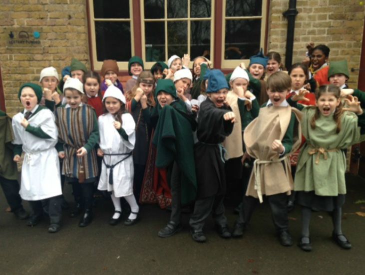 group of school kids dressed in viking costumes pose for the camera