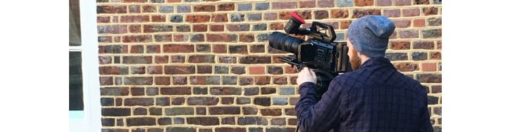 A camera man films in the tudor courtyard