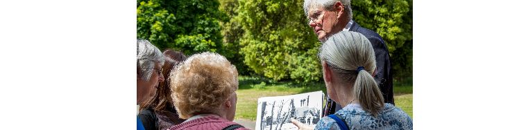 tour guide showing attendees an old image of the palace