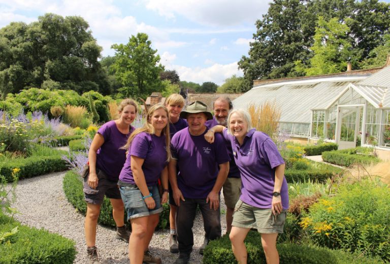 five members of the garden team smile for a photograph in the knot garden