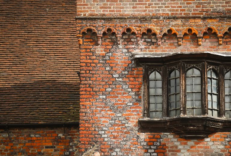 close up view of the wood framed gothic style window in the tudor courtyard