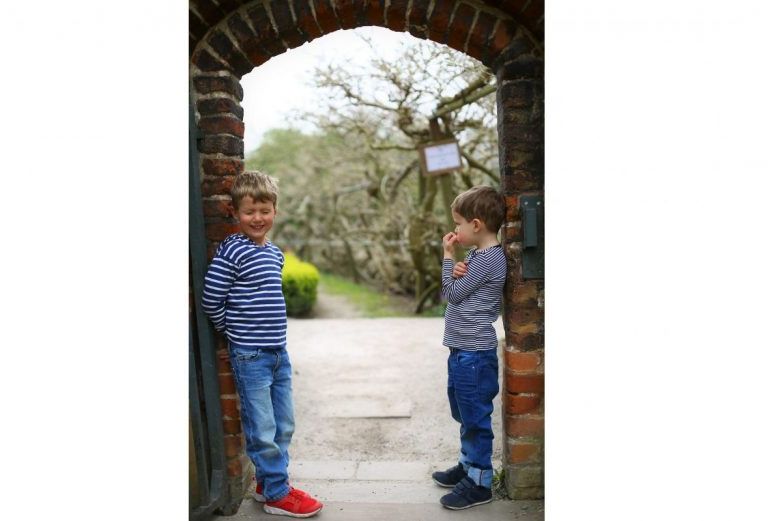 Photo competition- two children at walled gate by Alexandra Vanotti