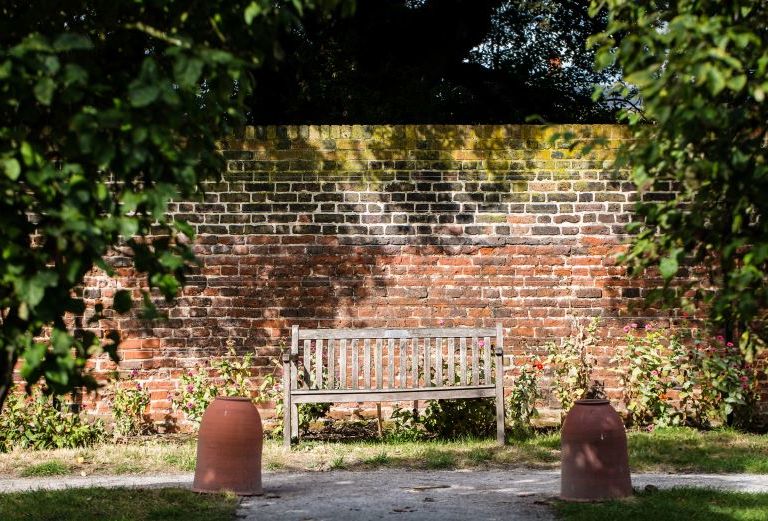 One of the many seating areas in the walled garden. Behind the bench is the beautiful mid 18th century wall