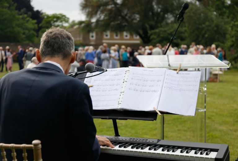 image shows man playing the piano