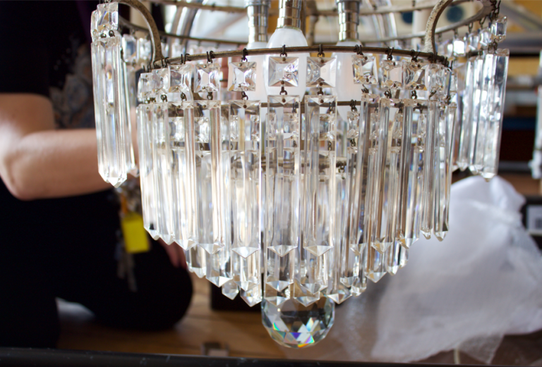 image shows a detailed picture of the crystal chandelier