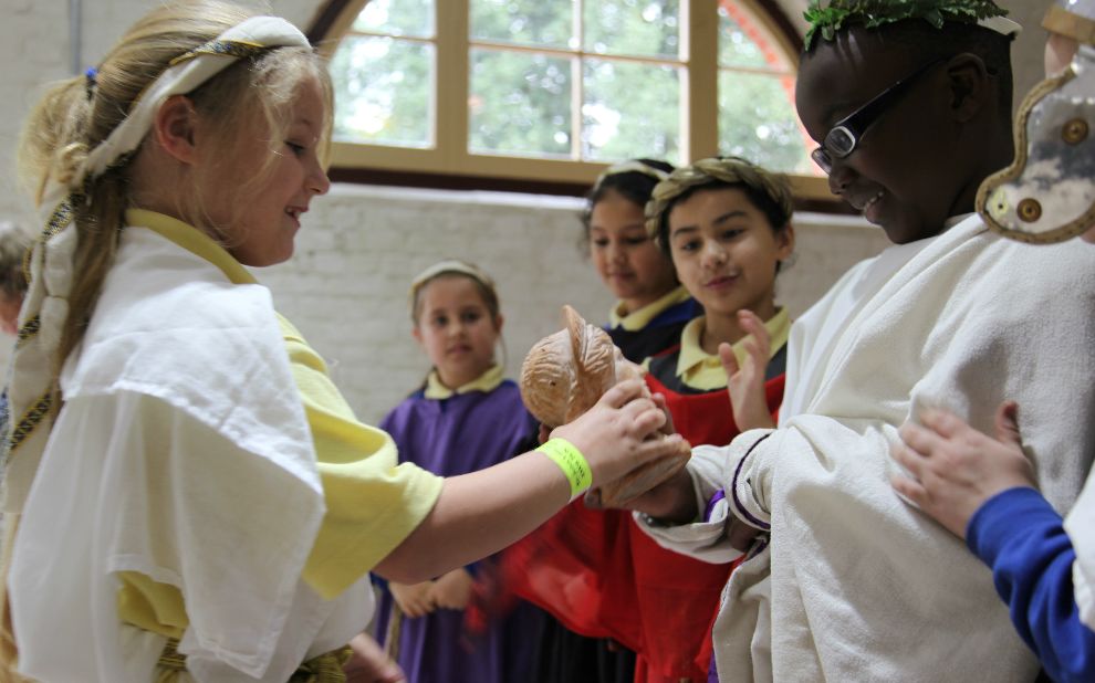 Children dressed in Roman costumes during a school session