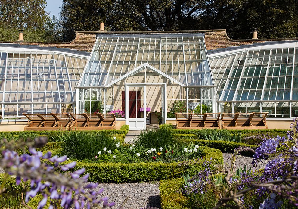 https://res.cloudinary.com/fulhampalace/image/upload/w_990,h_694,f_auto,c_fill,g_auto/fulhampalace/2019/03/Gardgen-full-of-flowers-with-greenhouse-in-background.jpg