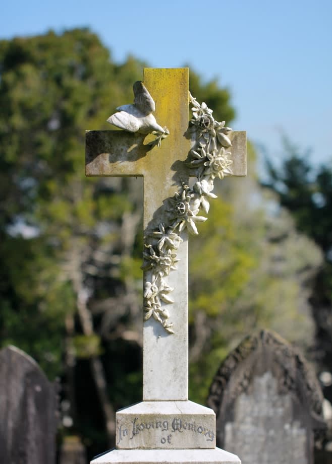 A grey headstone in tribute to a loved one who was cremated by a funeral home listed on Funeralocity in New York, NY