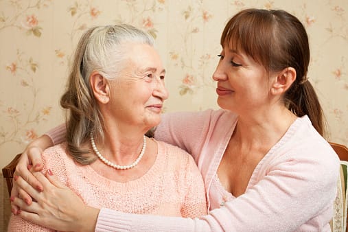 An elderly mom and daughter having a conversation about funeral planning, representing the funeral comparison website Funeralocity