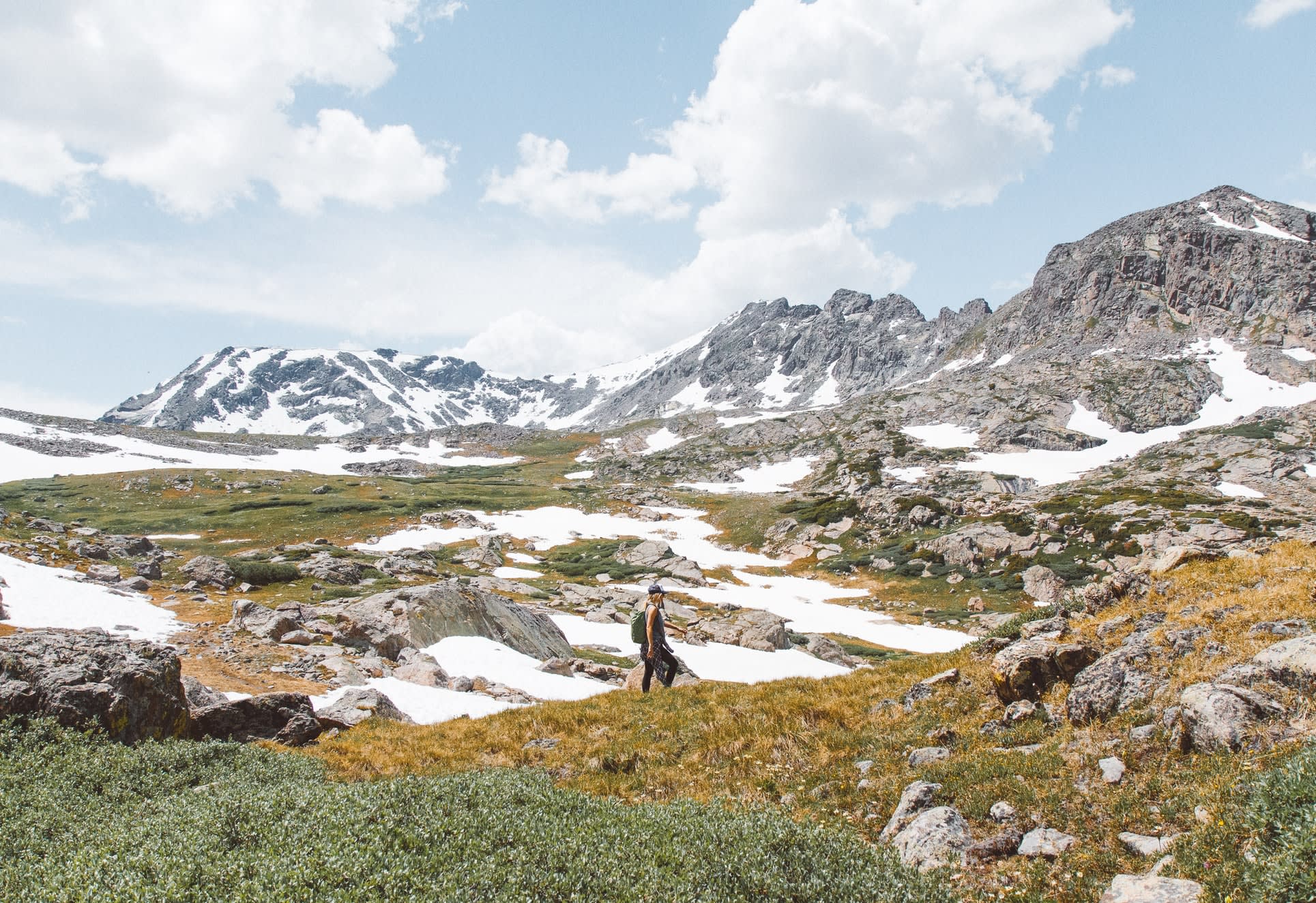 A woman hiking in the Rocky Mountains to scatter the ashes of a loved one after using Funeralocity to find a funeral home to perform the cremation