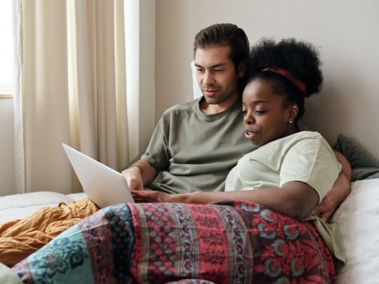 couple looking at online memorial