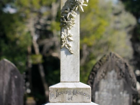 A grey headstone in tribute to a loved one who was cremated by a funeral home listed on Funeralocity in New York, NY