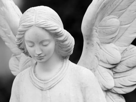 Stone angel statue. A funeral announcement is a way to provide people with information regarding funeral service arrangements.