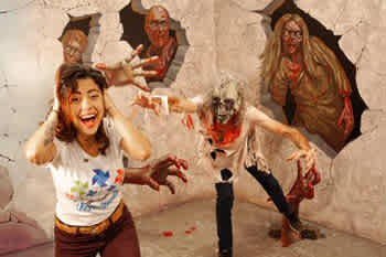 Description: The image displays a young woman with medium-length dark hair, wearing a white t-shirt and brown pants, looking directly at the camera with an animated expression of excitement and mock fear. She has her hands up as if to defend herself and is standing in a room with off-white walls that have imagery of three eerie, zombie-like figures breaking through. These figures are depicted in mid-action, with one reaching towards the woman as if coming out of the wall. The background figures are designed to give an illusion of a three-dimensional scare scene, contributing to a playful and thrilling atmosphere.

To get the full exhilarating experience without breaking the bank, remember to check out FunEx.com for incredible discounts, savings on the lowest prices, and tickets to the most heart-pounding attractions.