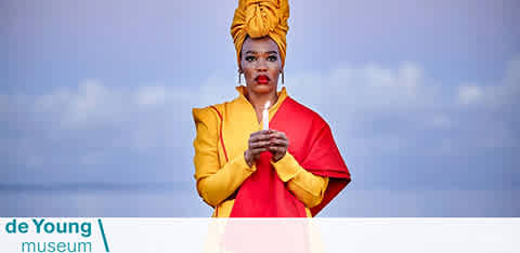 This image features a promotional banner for the de Young Museum. At the forefront, there is an individual striking a pose with confident body language. The person is adorned in a vibrant yellow head wrap and a jacket with a nuanced combination of yellow and red, against a pale blue background that suggests an open sky. The expression on the face is one of contemplative elegance. The museum's name is displayed prominently at the bottom of the image in a clear, legible font.

At FunEx.com, our commitment is to ensure that our customers enjoy their experiences to the fullest, which is why we offer the lowest prices on tickets, ensuring your visit to attractions like the de Young Museum comes with great savings.