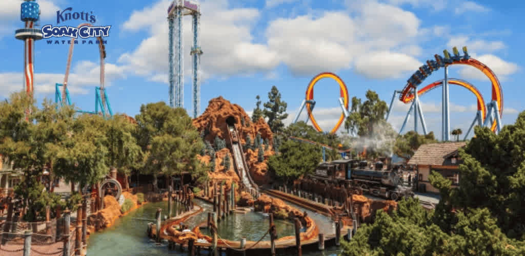 This image showcases a vibrant scene at Knott's Soak City Water Park and surrounds at Knott's Berry Farm. The foreground features a water attraction with a steep brown rocky structure and a watercraft making a splash at the base amid the meandering water channel. Lush green trees adorn the landscape, providing a natural contrast to the excitement of the rides. In the midground, a train with an old-fashioned steam locomotive winds along the tracks. The background highlights the thrilling silhouette of roller coasters with impressive orange loops against a blue sky, alongside a tall drop tower ride. Family fun and the promise of adventure fill the scene with energy.

At FunEx.com, we're all about the rush of excitement without the plunge in your wallet—enjoy the thrill of the lowest prices and terrific savings on tickets for unforgettable experiences!