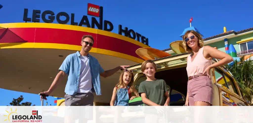 Image shows a family of three smiling in front of the LEGOLAND Hotel entrance. The hotel sign is displayed prominently above. The father and two children appear happy and are casually dressed for a day of fun, while a colorful building with a playful design is visible in the background.