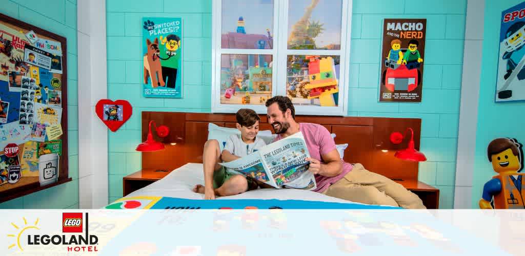 Adult and child reading a brochure in a colorful LEGO-themed hotel room.