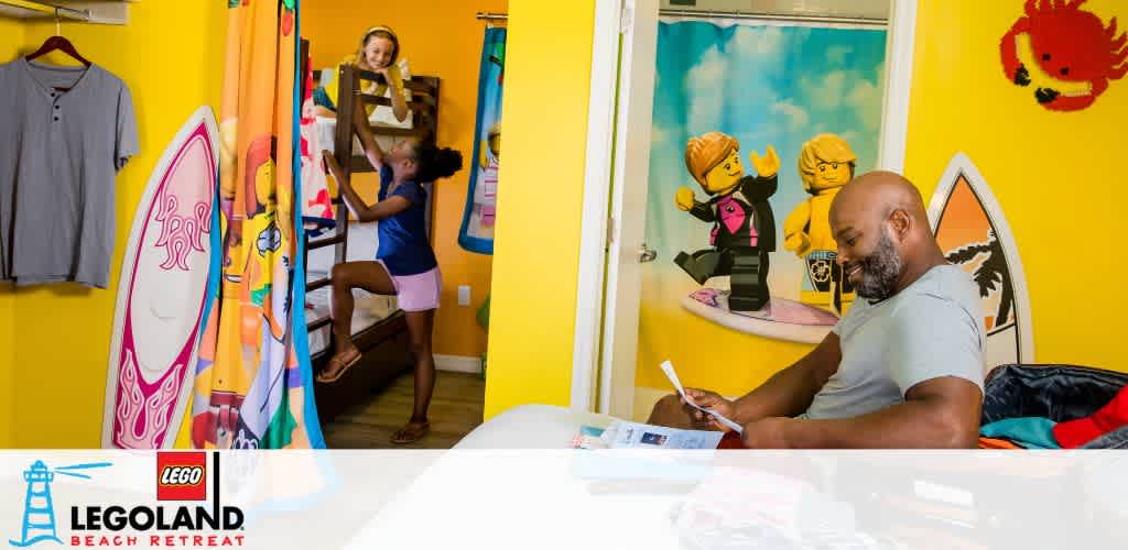 Family enjoys a vibrant Legoland Beach Retreat room with LEGO decor.