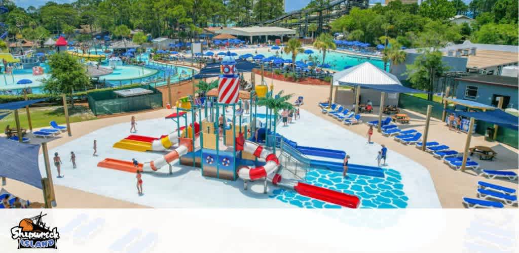 A vibrant water park with pools, slides, a play area, and loungers under a sunny sky.