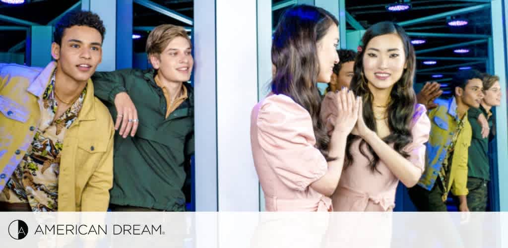 Image shows four young adults standing in line at an entrance with vibrant blue neon lighting. The two in front, one male and one female, appear to be chatting and smiling. Behind them, two females are engaged in an animated conversation. They're stylishly dressed, suggesting a casual yet fashionable event. The logo 'AMERICAN DREAM' is displayed at the bottom.