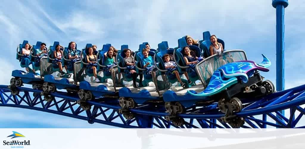 A group of excited riders is seated in a blue coaster adorned with wave patterns, soaring against a clear sky. Below, the coaster is the SeaWorld logo. The image conveys the thrill of a theme park ride.