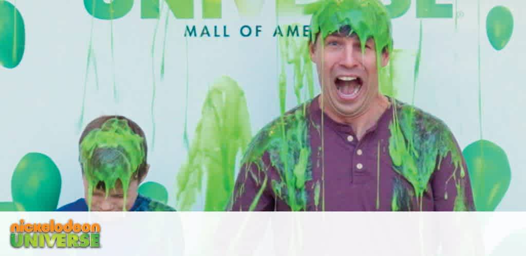 Two people getting slimed with green goo, with the 