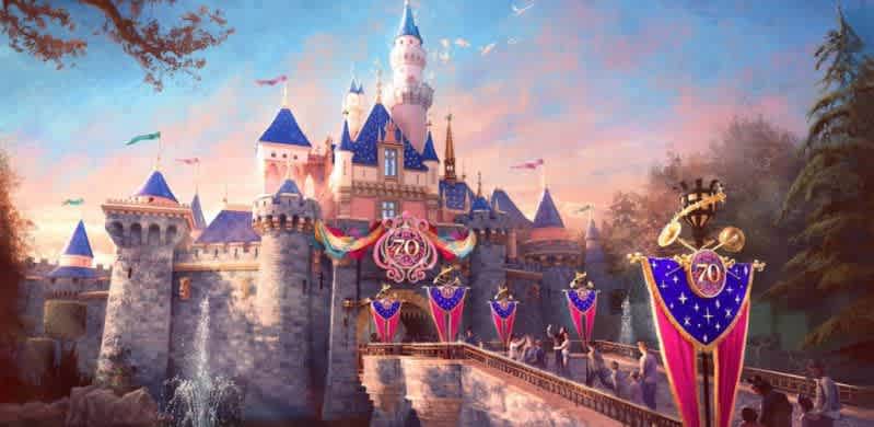 Colorful castle with tall spires and a bridge adorned with vibrant red and blue banners celebrating its 70th anniversary. Flags atop the turrets flutter in the breeze under a serene sky with soft clouds. Visitors gather near the entrance, creating a lively atmosphere. Lush greenery and fountains enhance the picturesque scene, evoking a sense of enchantment and excitement.